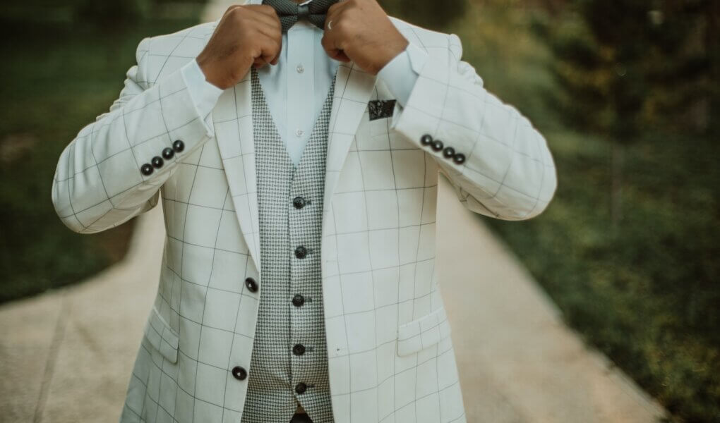 man in white suit jacket