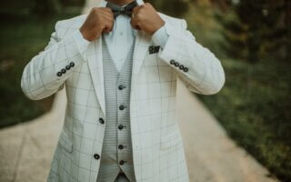 man in white suit jacket