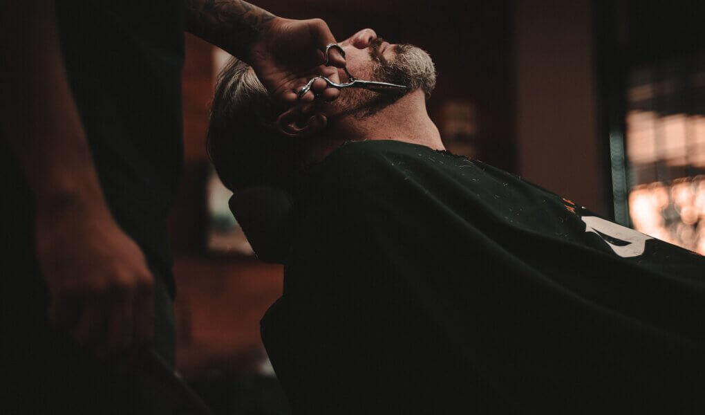 man sitting on barber's chair