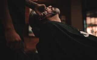 man sitting on barber's chair