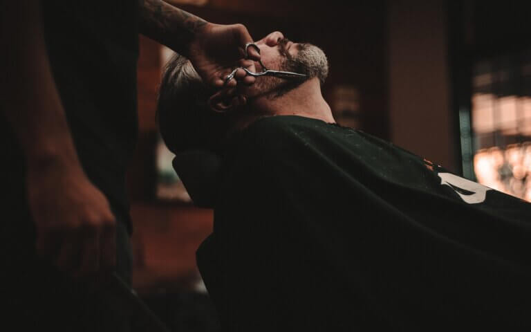 man sitting on barber's chair