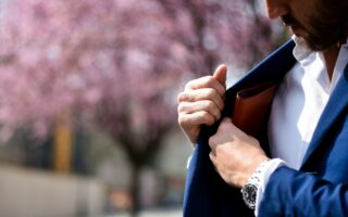 man putting wallet on suit pocket