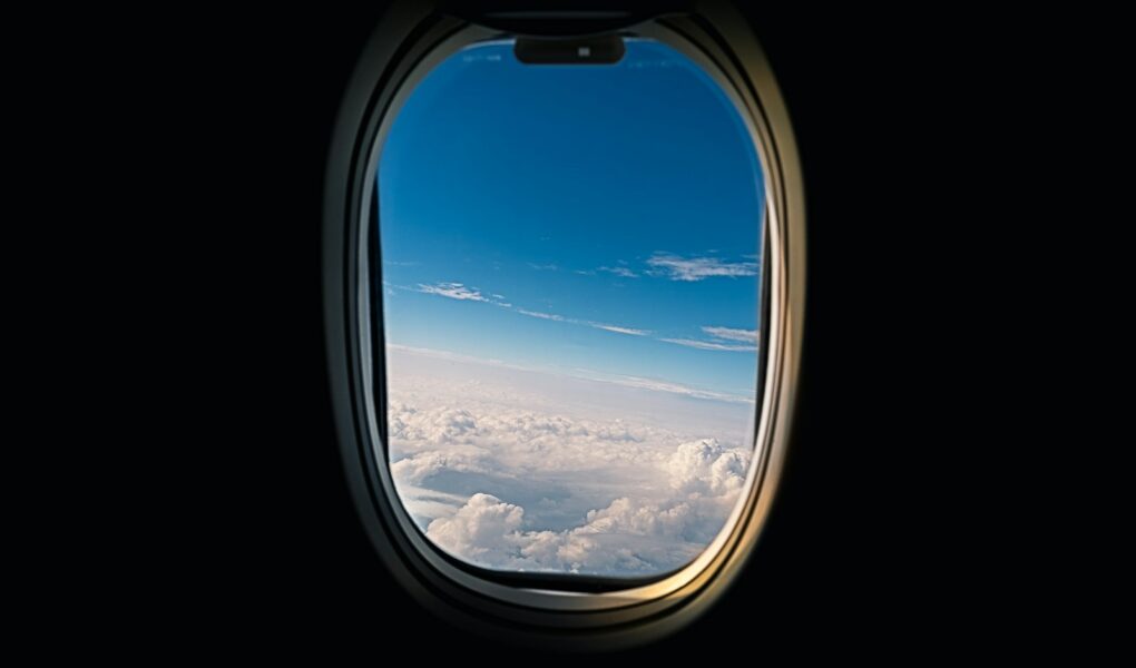 airline window viewing white clouds