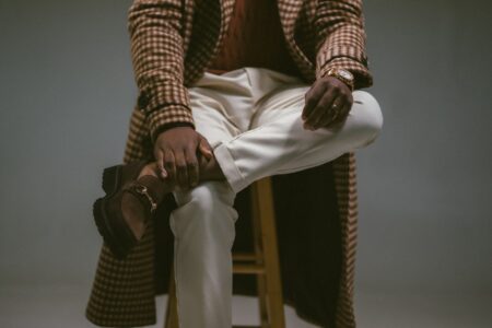 A man in stylish, cozy apparel poses.