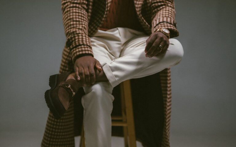 A man in stylish, cozy apparel poses.
